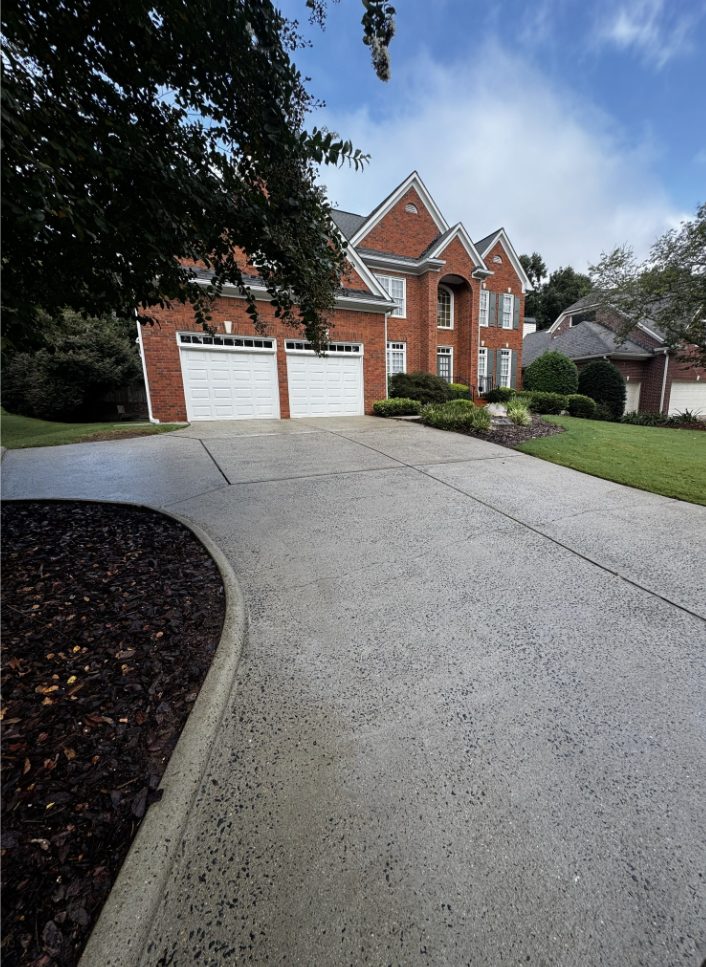 The same East Hampton, Marietta driveway after pressure washing, with the algae and mildew removed and the concrete restored to an even color