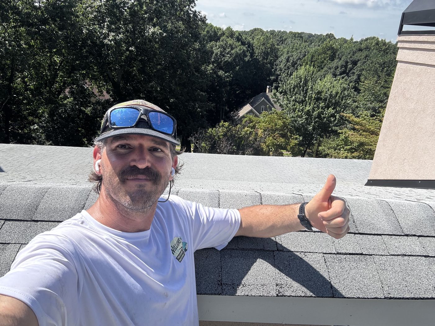 Matt Williams, owner of Williams' Pressure Washing Co., on a roof in East Cobb, Georgia during a roof soft wash