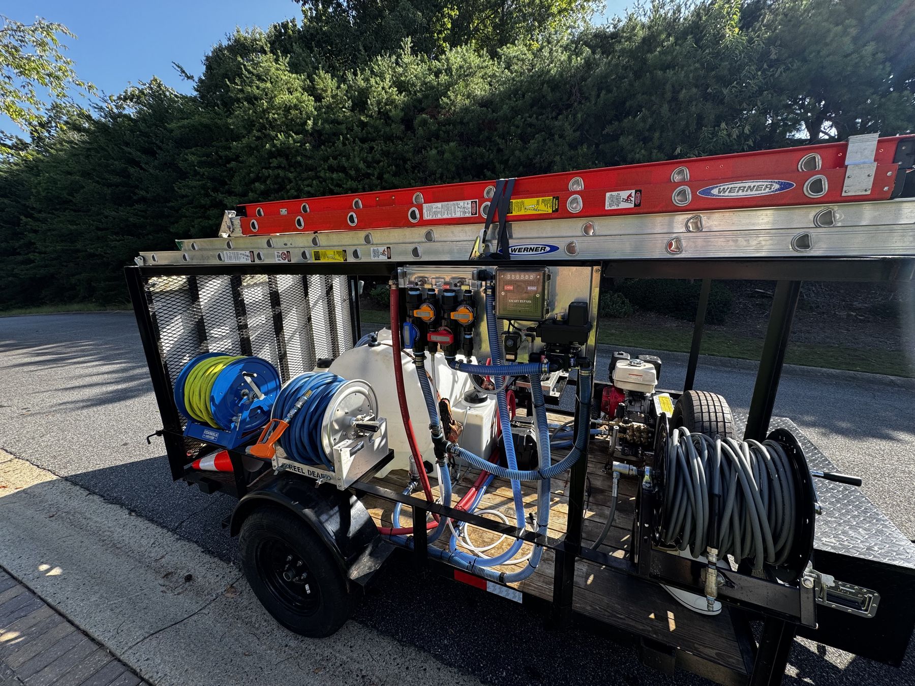 Williams Pressure Washing trailer rig with hose reels, water tank, soft wash system and ladders