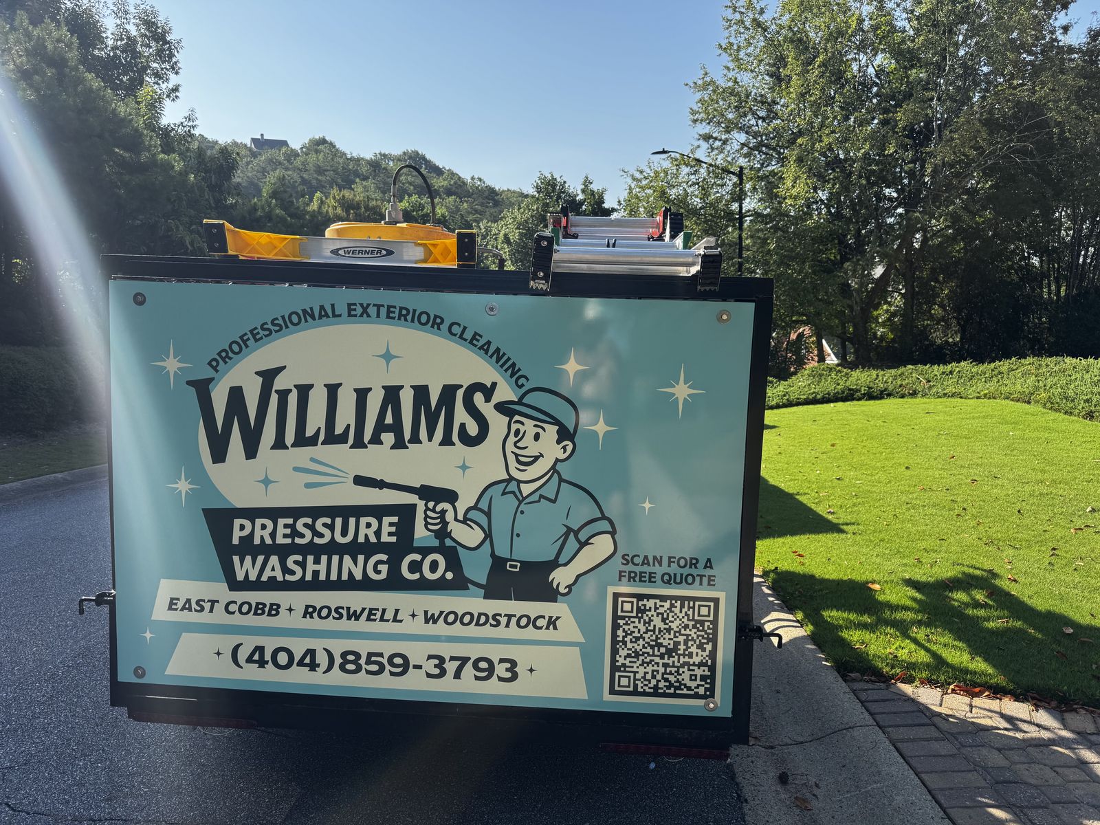 Williams Pressure Washing Co. branded trailer showing service areas East Cobb, Roswell and Woodstock and phone number 404-859-3793